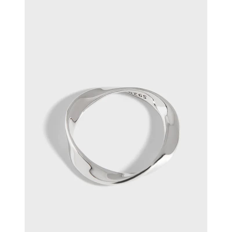 Polished sterling silver ring with a flowing, wavy band on a light background.