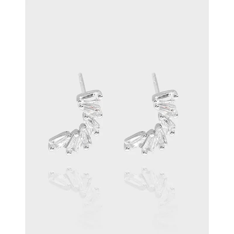 Polished sterling silver drop earrings with a curved arc of baguette-cut stones.