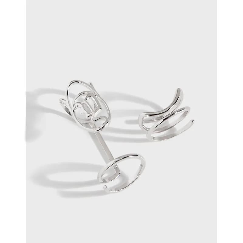 Polished sterling silver ring with an openwork floral crown on a clean white background.