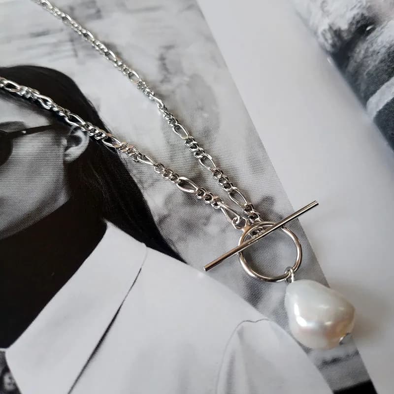 Polished sterling silver necklace with a T-bar toggle, circular ring, and a dangling pearl