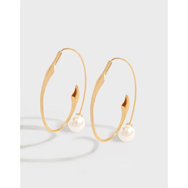 Polished sterling silver pearl drop hoops with open teardrop ends.