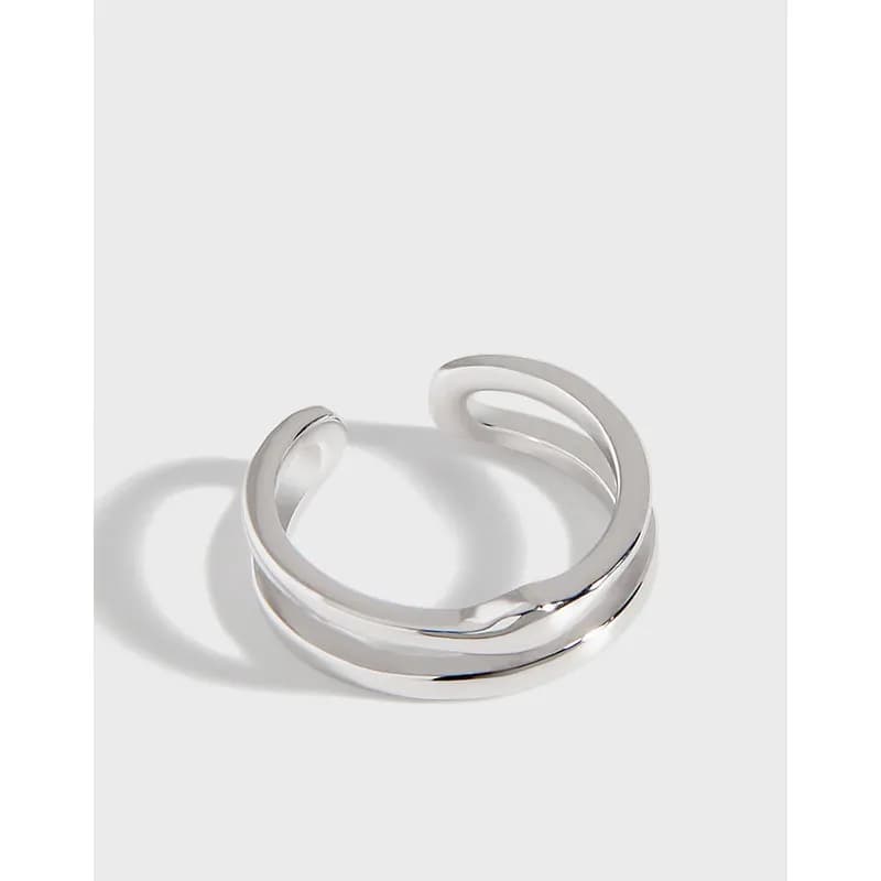 Polished sterling silver double-band ring with an open gap on a light background.