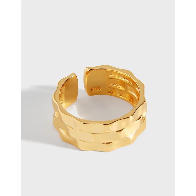 Gold-tone triple-wave sterling silver ring with three stacked, wavy bands on a white background.