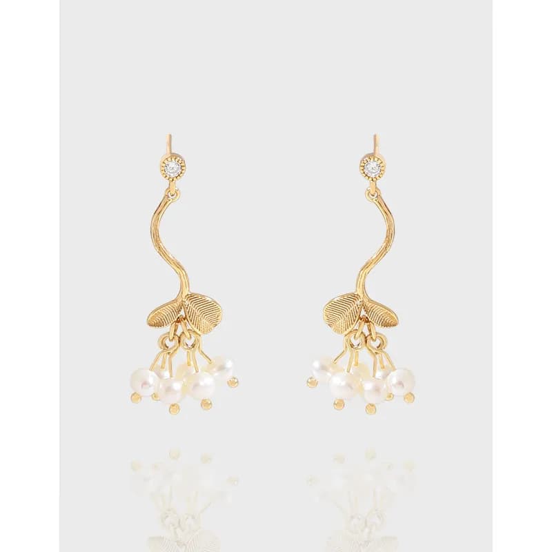 Polished sterling silver leaf-inspired drop earrings with pearl clusters hanging from a curved stem.