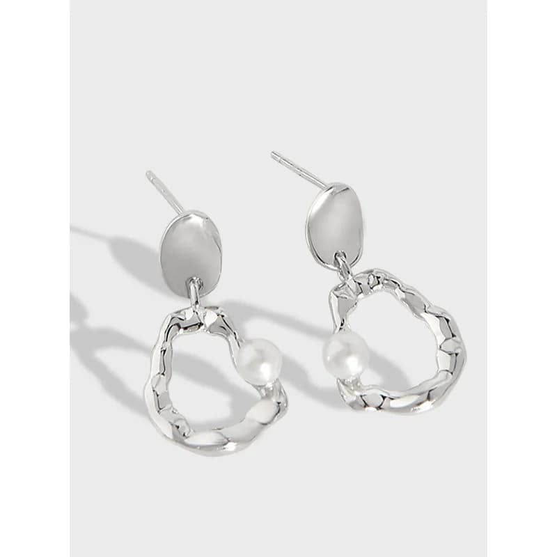 Polished sterling silver earrings with oval studs and hammered circular hoops featuring pearl accents.