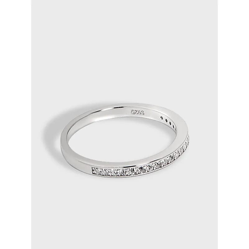 Polished sterling silver ring with a row of small pavé diamonds along the outer edge.