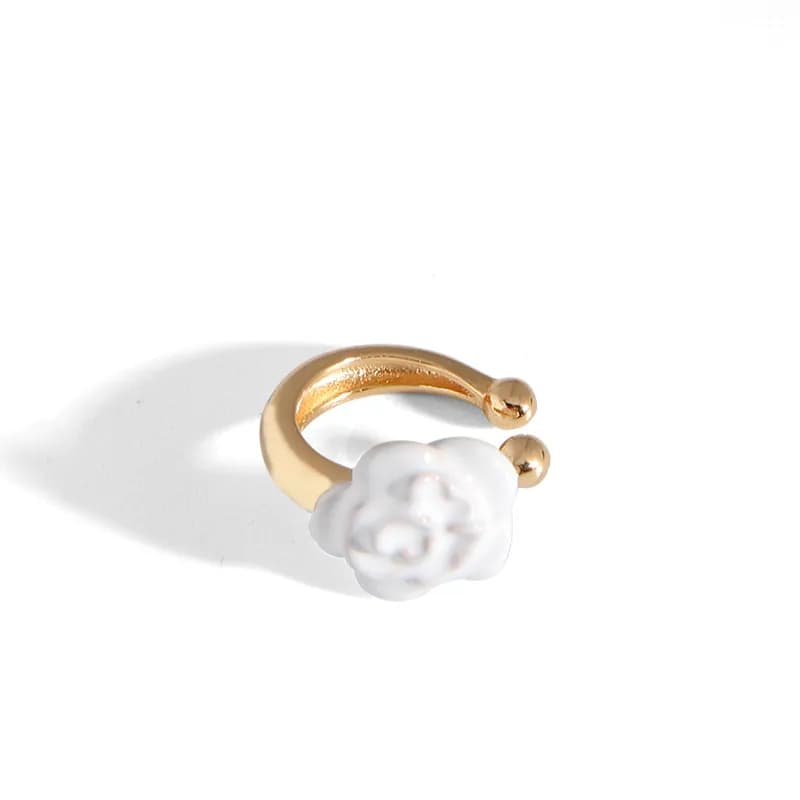 Polished sterling silver hoop earring with a small white flower bead.