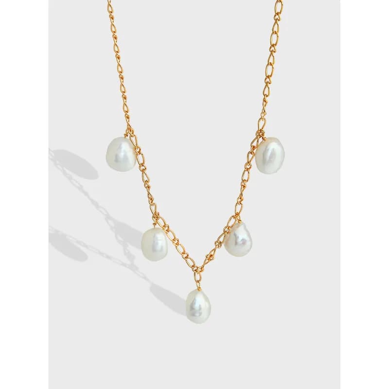 Gold-tone necklace with multiple irregular white pearls along the chain and a central dangling pearl
