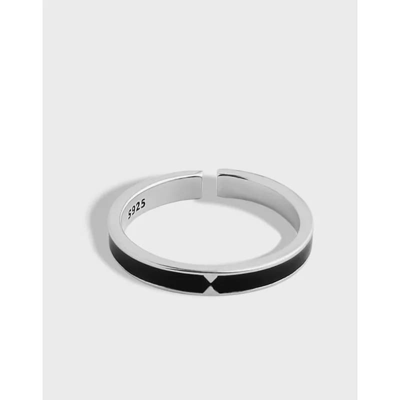Polished sterling silver open-ring with a black enamel inlay on the outer edge.