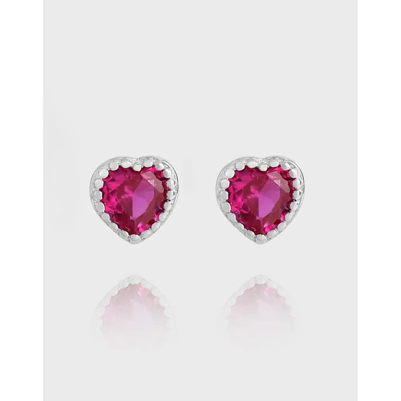 Pair of heart-shaped pink gemstone stud earrings in a polished sterling silver setting