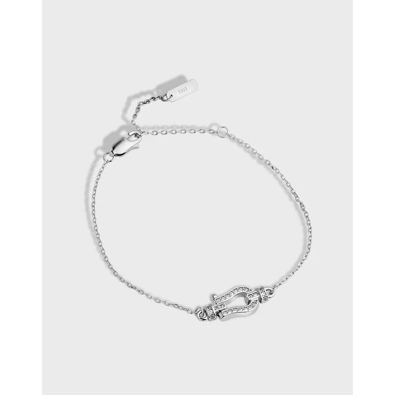 Delicate sterling silver bracelet with a pavé U-shaped charm on a clean white background.