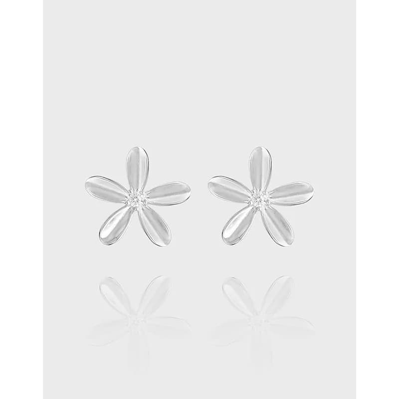 Polished sterling silver five-petal flower stud earrings on a neutral background.