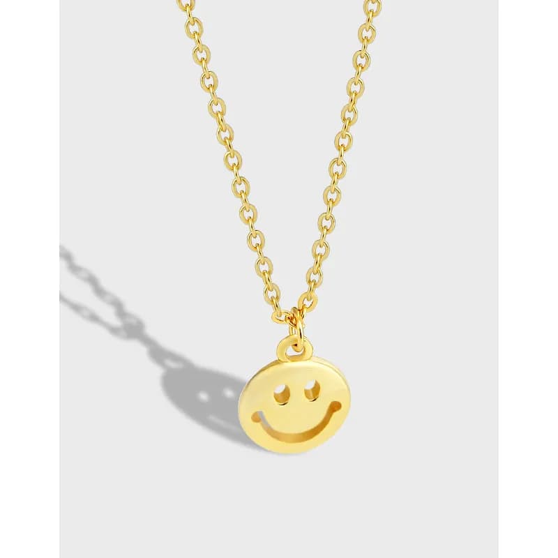 Polished smiley face pendant on a fine chain necklace.