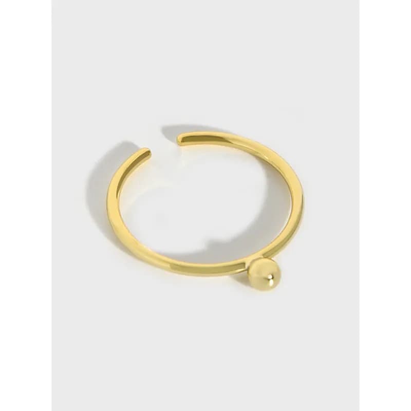 Open-ended polished sterling silver ring with a small ball end on one side.