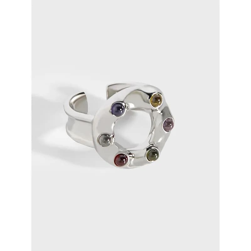 Polished sterling silver circle ring with colorful bezel-set stones around the circumference