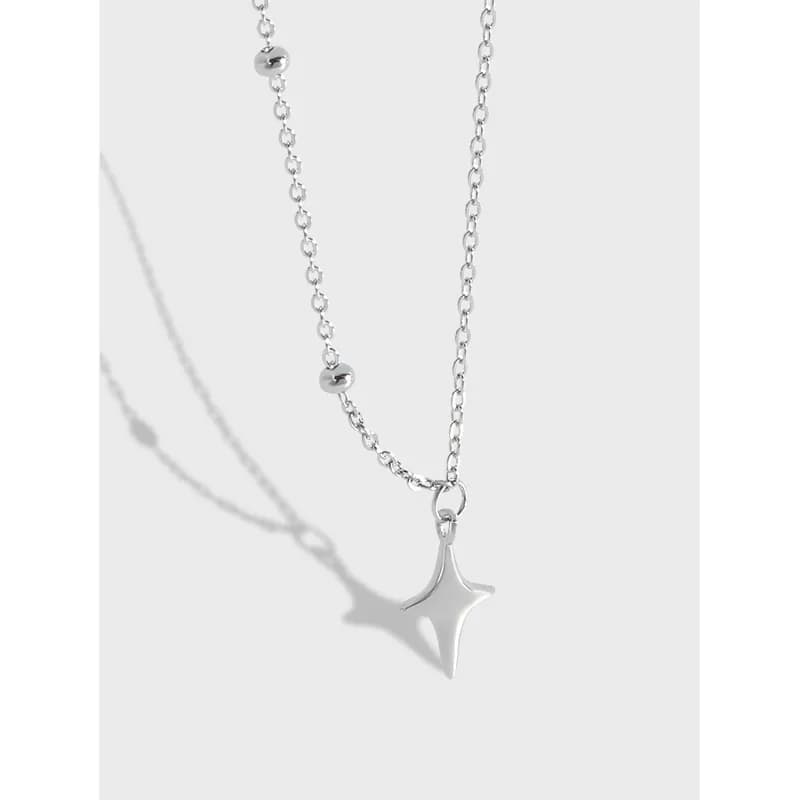 Sterling silver star pendant on a beaded chain necklace.