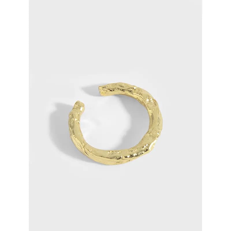 Open textured sterling silver ring with an organic, rugged surface shown on a light background.