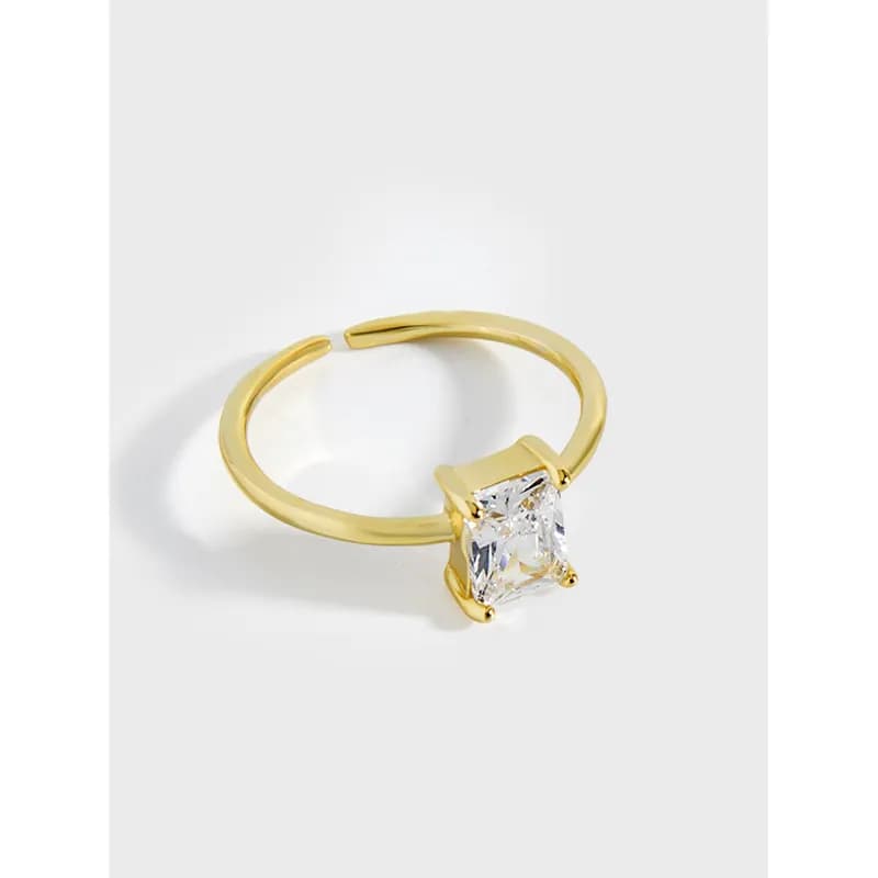 Gold-tone sterling silver ring with a square-cut solitaire stone set in a four-prong setting.