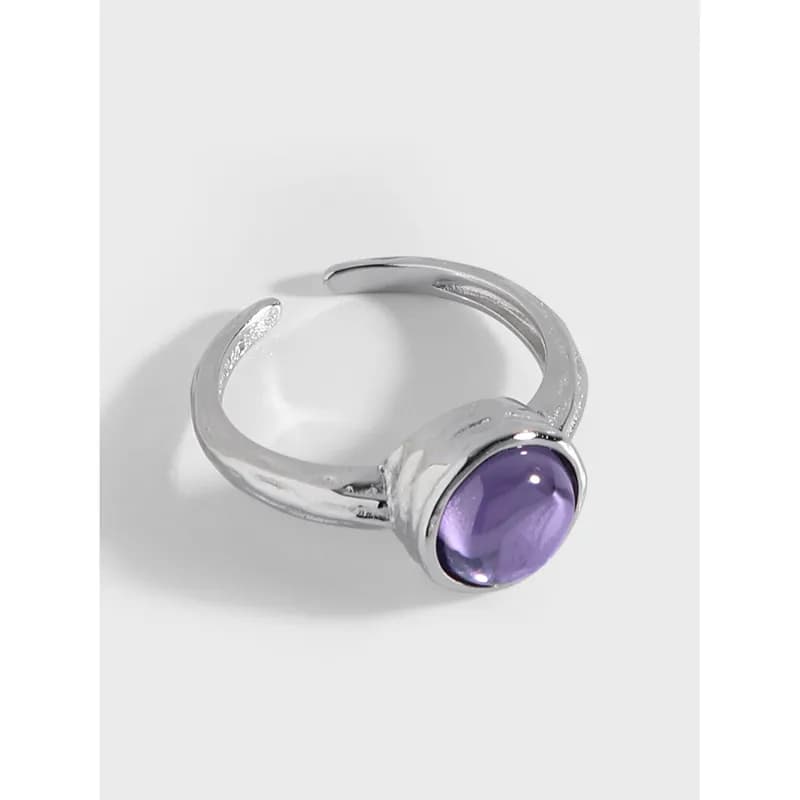 Polished silver ring with a round purple cabochon bezel-set gemstone