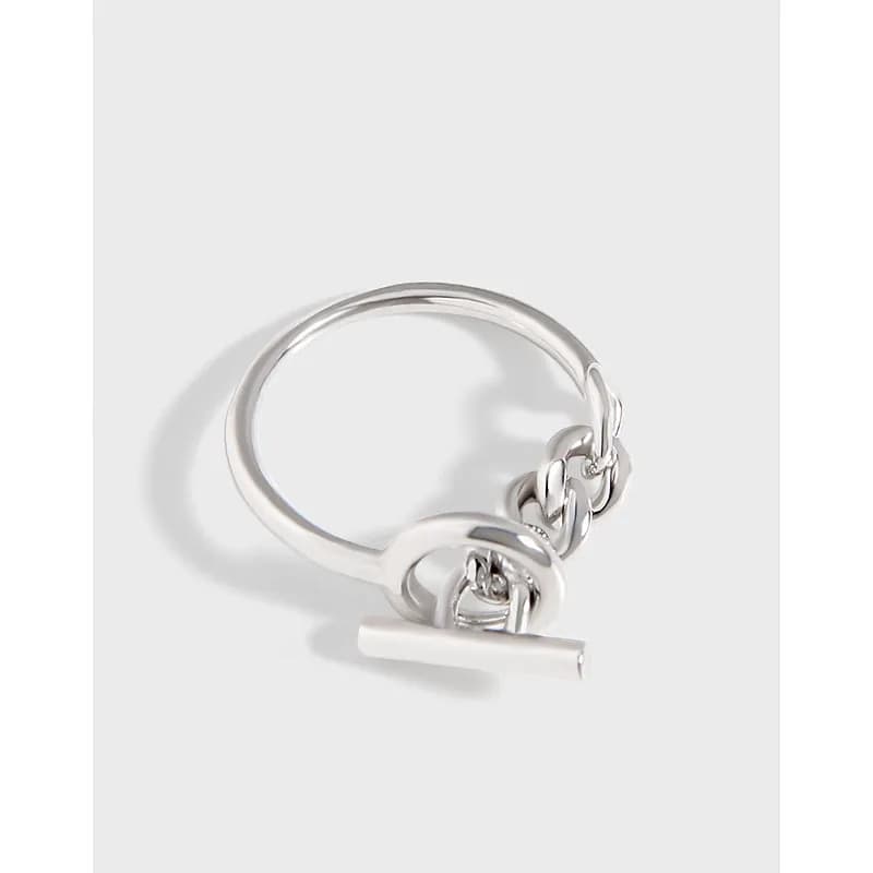 Polished silver ring with a chain-link charm and horizontal bar toggle detail