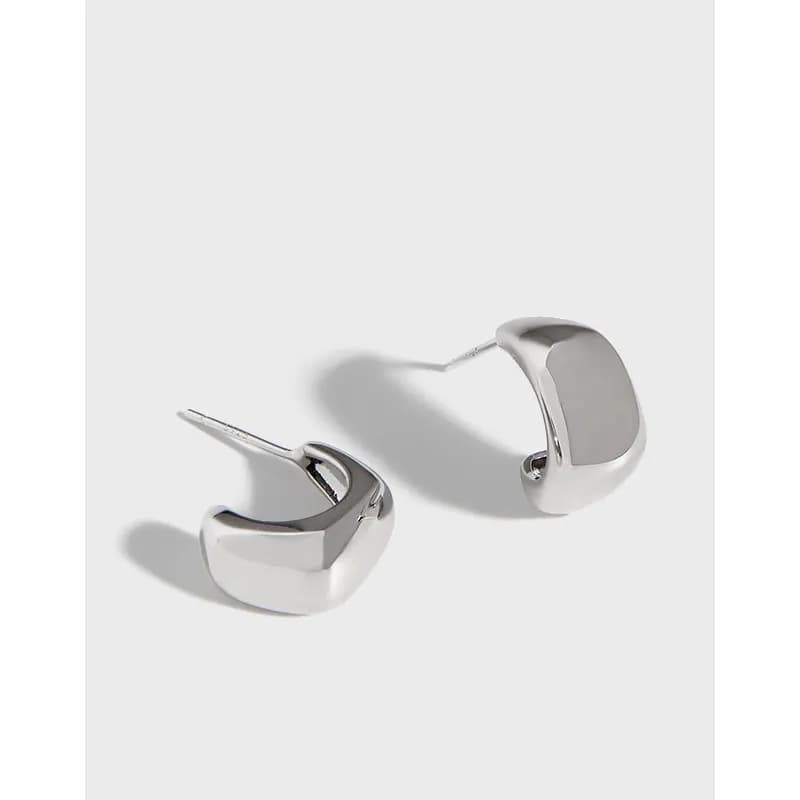 Polished sterling silver chunky square hoop earrings on a light background