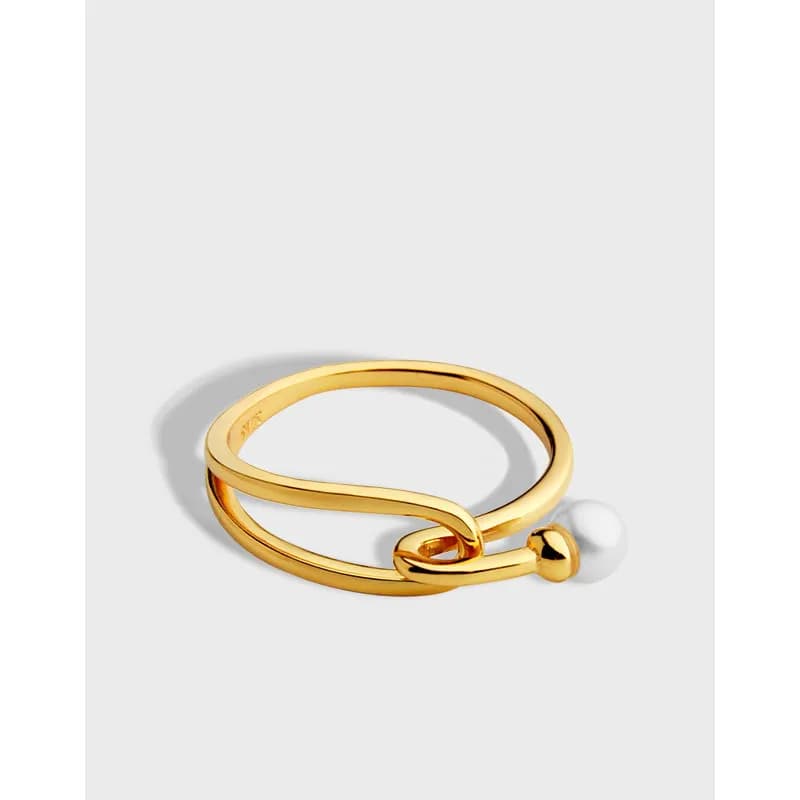 Gold-tone polished ring with an open S-curve and a small pearl bead on the end.