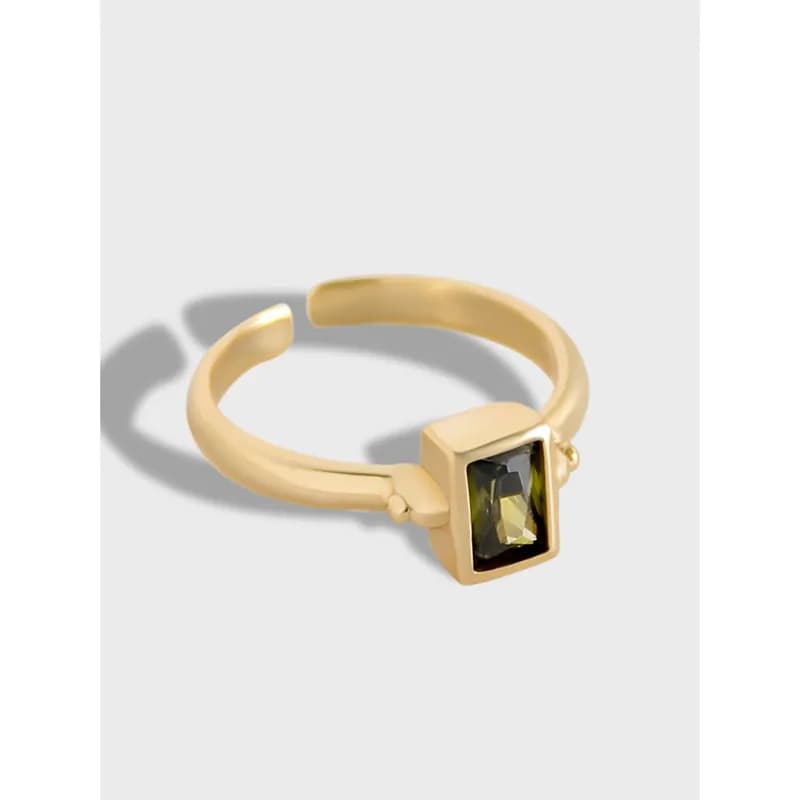 Ring featuring a square bezel with a rectangular green gemstone on a smooth band