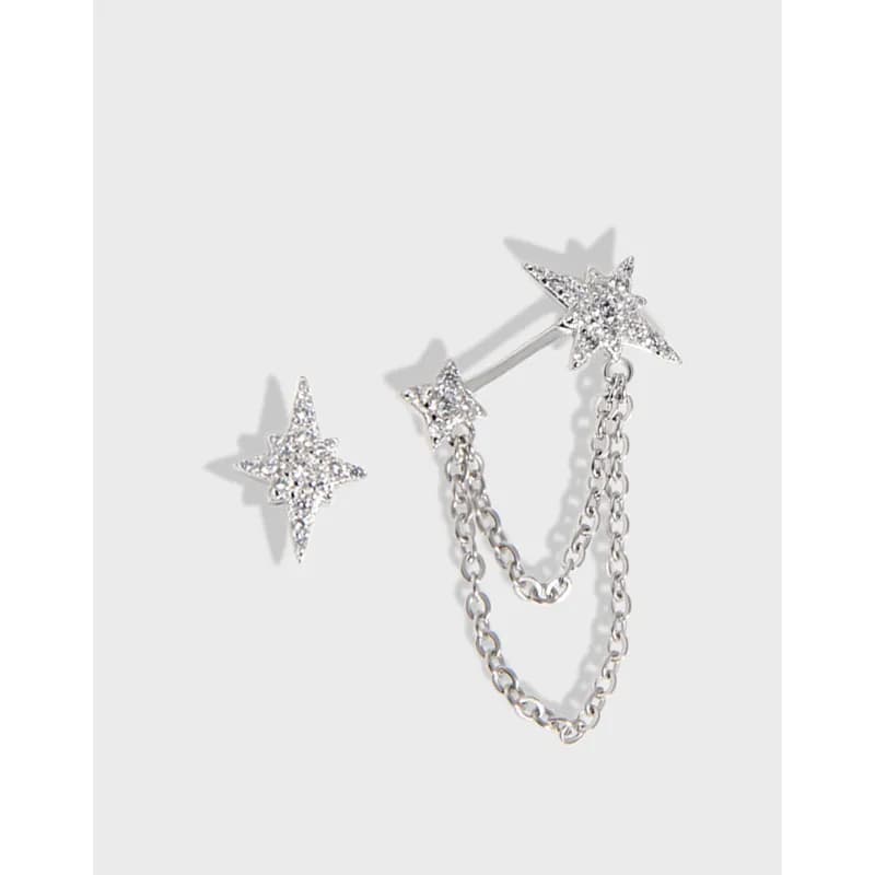 Sterling silver starburst earrings with a chain-dangled cuff design and pavé-set stones.