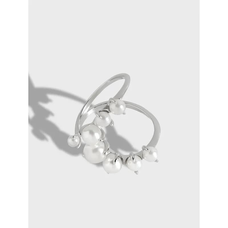 Polished sterling silver ring with a cluster of white pearls along the band.