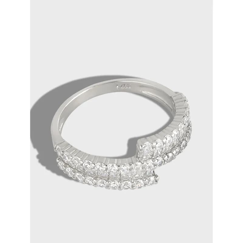 Polished sterling silver ring with two parallel rows of clear stones along the outer edge.
