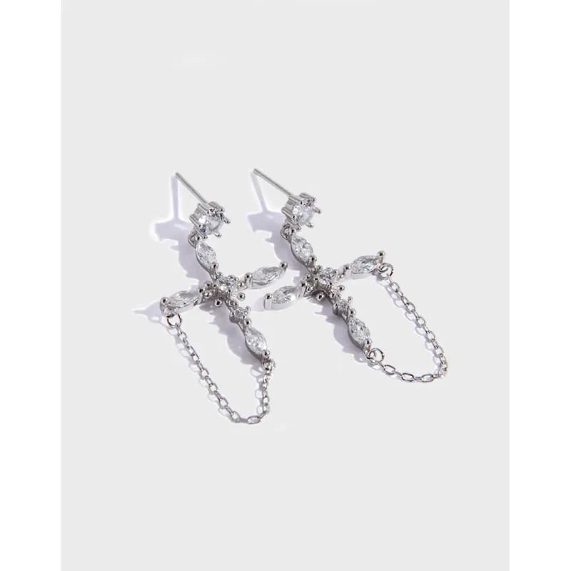 Polished sterling silver earrings with marquise stones forming a curved botanical motif and a delicate chain drop.