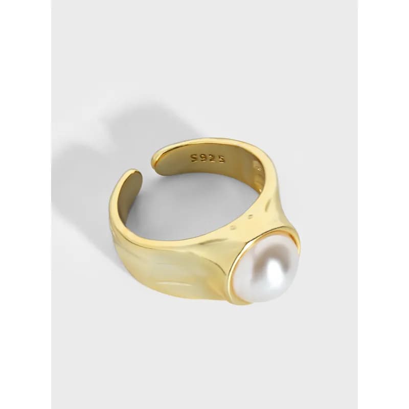 Polished sterling silver ring with a large white pearl bezel-set on a sculpted, wide band.