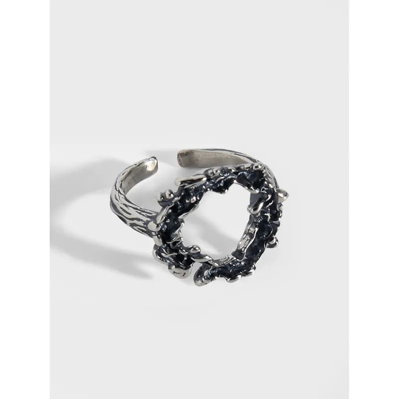 Sterling silver open-ring with a jagged circular centerpiece and polished band
