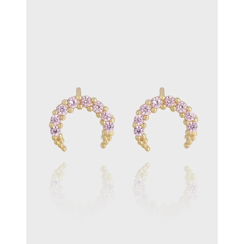 Pair of polished sterling silver crescent earrings with pink stones and small bead details along the curve.