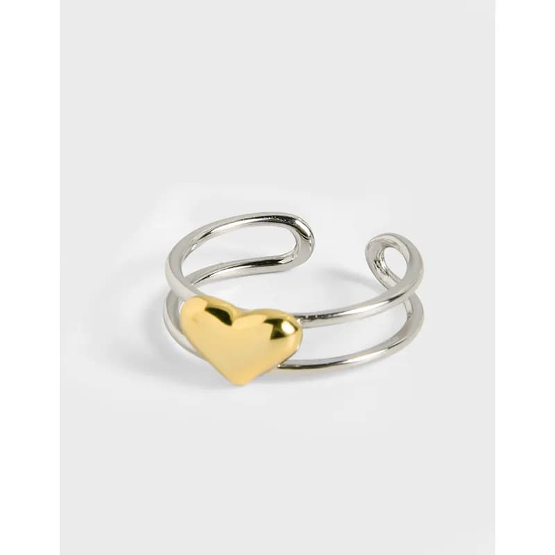 Polished sterling silver double-band ring with a small gold heart accent on the front.