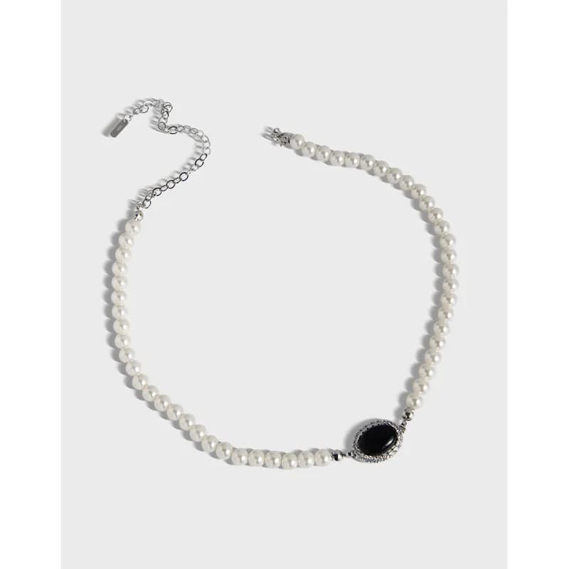 Pearl bead necklace with a black oval onyx pendant and pavé surrounding halo