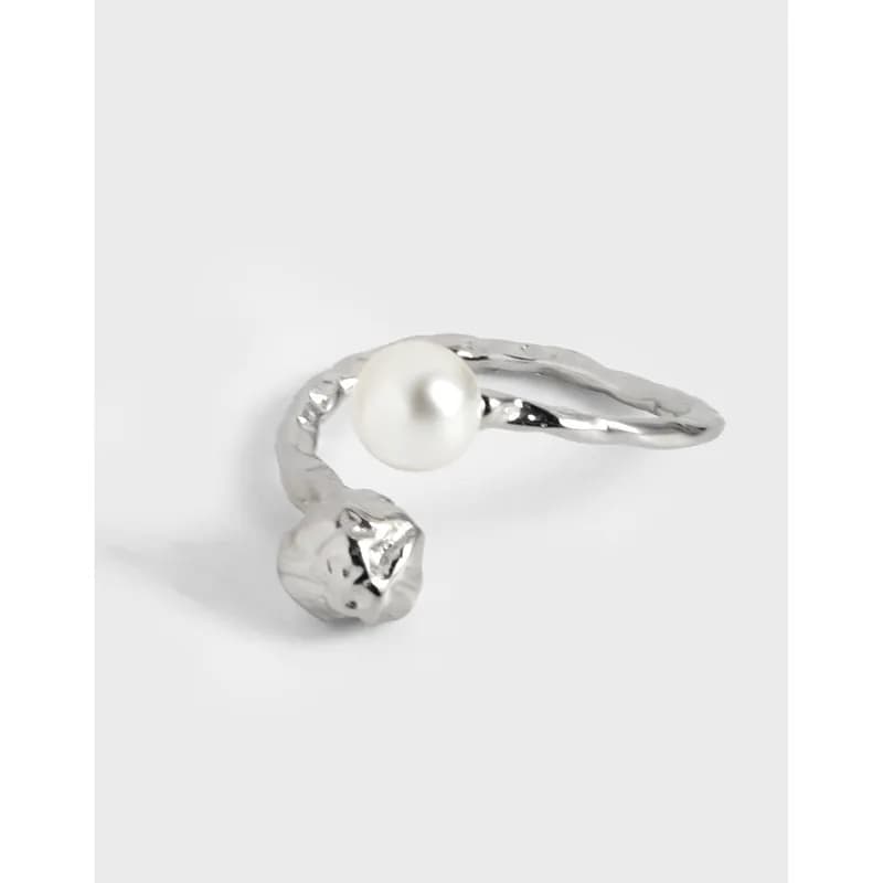 Open-wrap sterling silver ring with a pearl on one end and a rough-cut stone on the other.