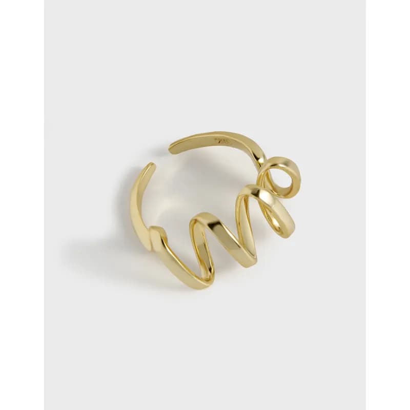Polished spiral open ring with coiled loops on a light background.