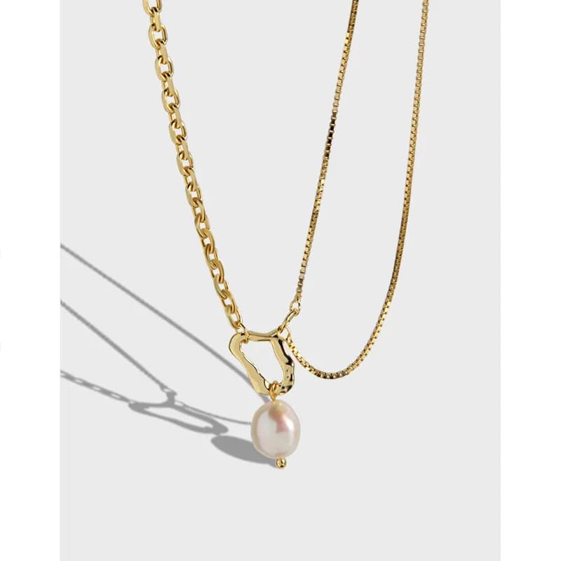 Polished sterling silver necklace with an irregular loop pendant and pearl drop