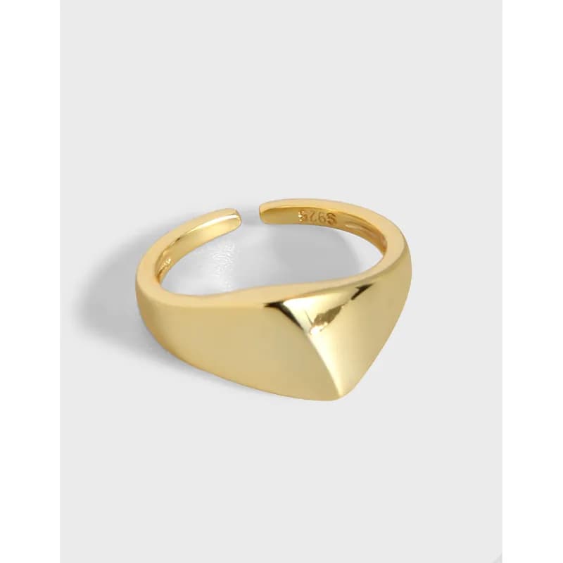 Polished sterling silver ring featuring a wide band and a prominent pyramid front detail.