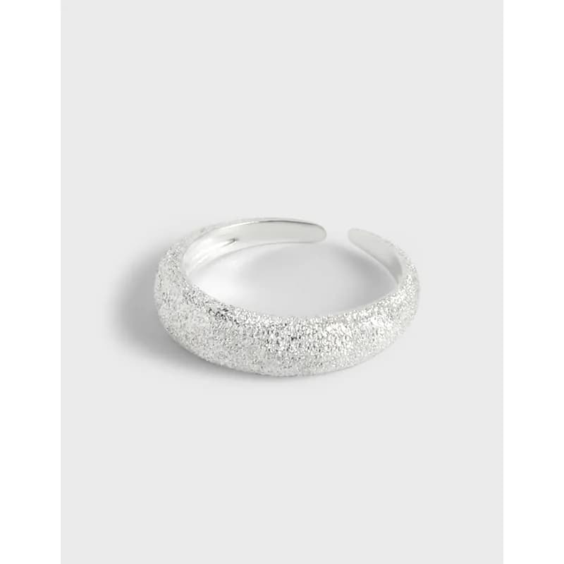 Open-back sterling silver ring with a heavily textured, pebble-like exterior surface.