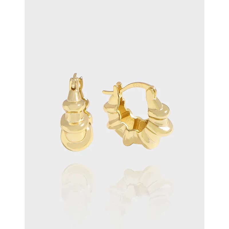 Polished sterling silver stacked disk hoop earrings with a chunky, sculptural hoop design