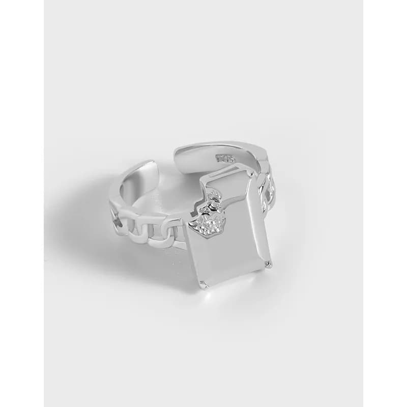 Polished sterling silver ring with a square plate top and linked band visible from an angled view.