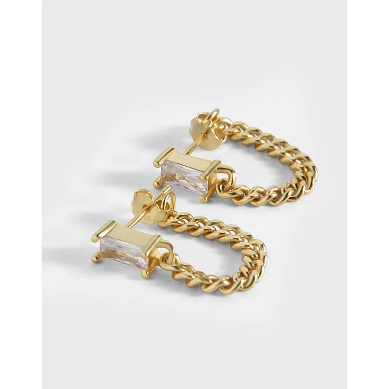 Polished metal hoop earrings with a rectangular crystal bar at the front