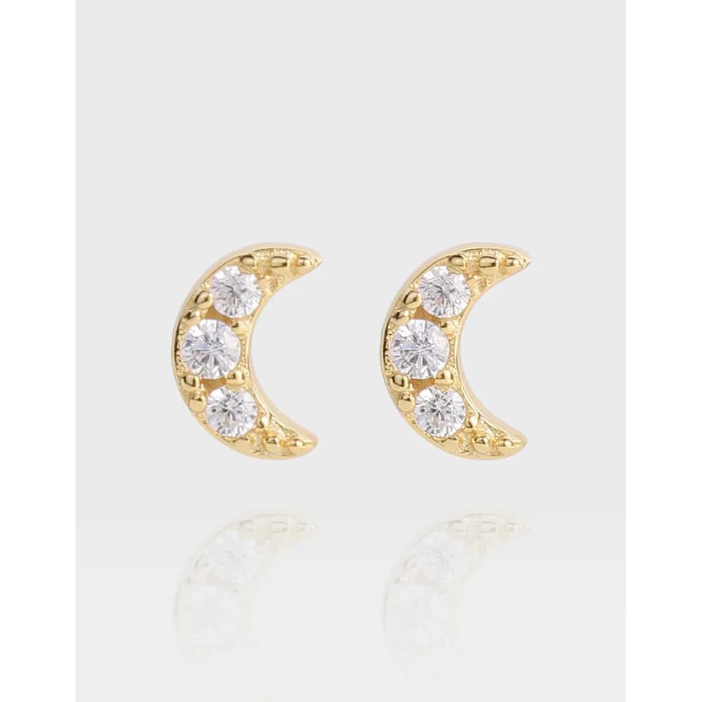 Polished sterling silver crescent moon stud earrings with three stones along the inner curve.