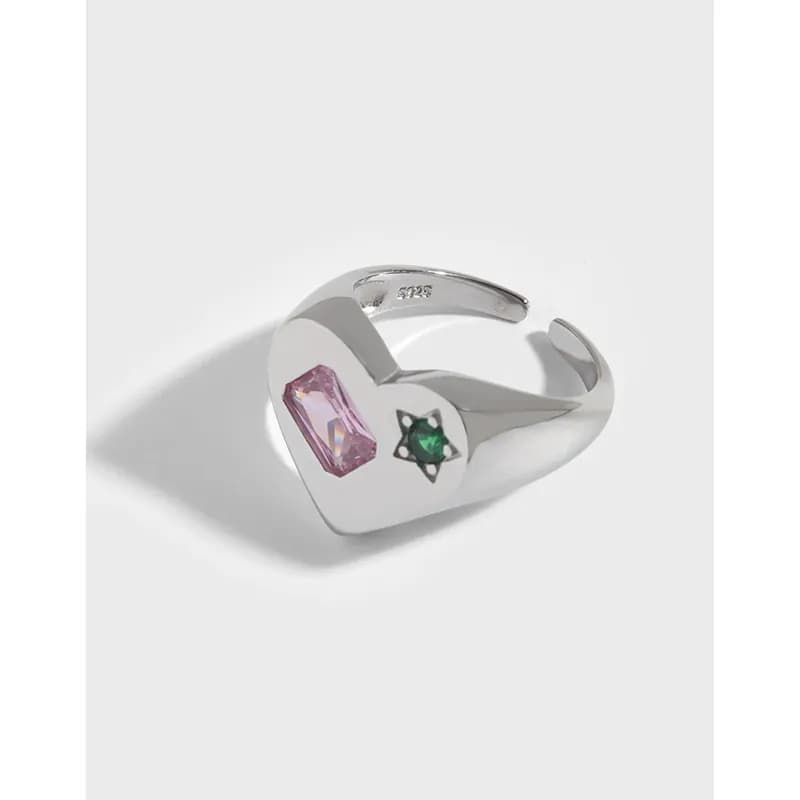 Polished sterling silver heart-shaped ring with pink and green stones on the face.