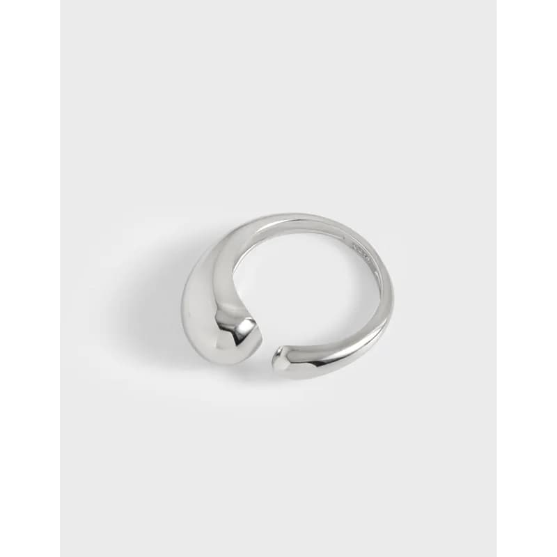 Polished sterling silver open crescent ring with rounded ends on a white backdrop.