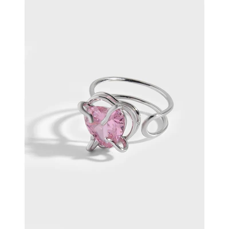 Polished silver-tone ring with a pink faceted gemstone held by delicate prongs