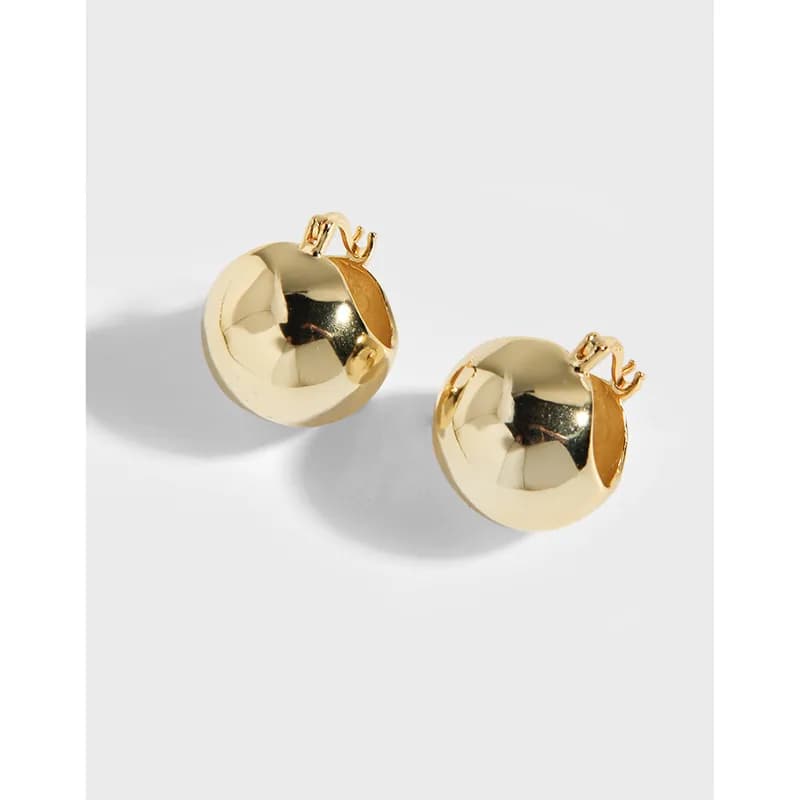 Gold-toned polished sphere stud earrings on a white background
