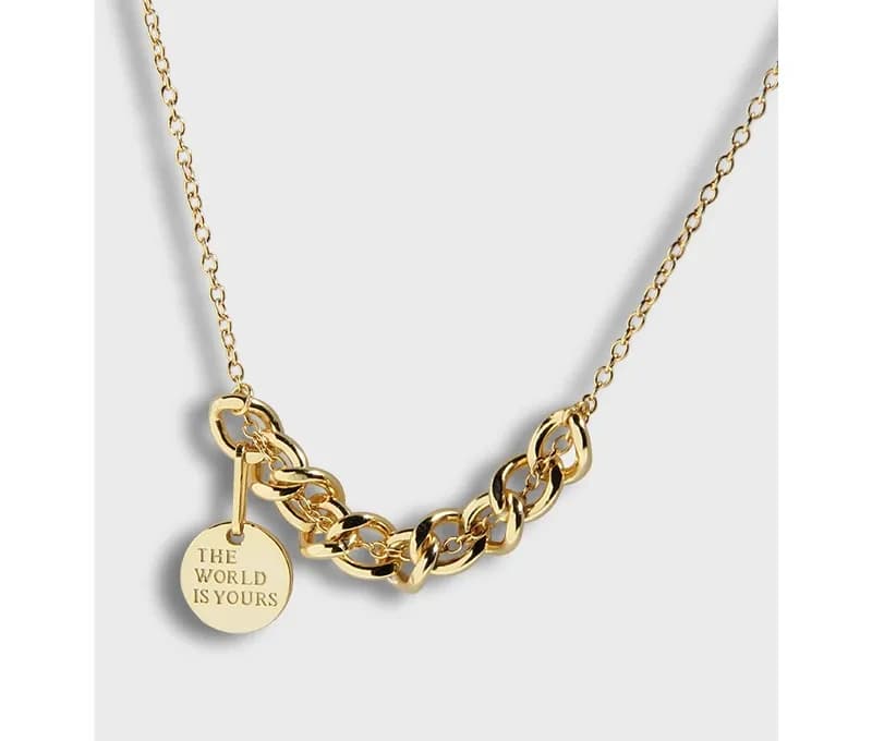 Polished sterling silver chunky chain necklace with a round charm engraved The World Is Yours